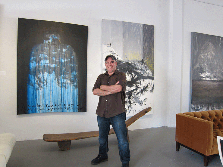 Danilo Gonzalez, in front of his work