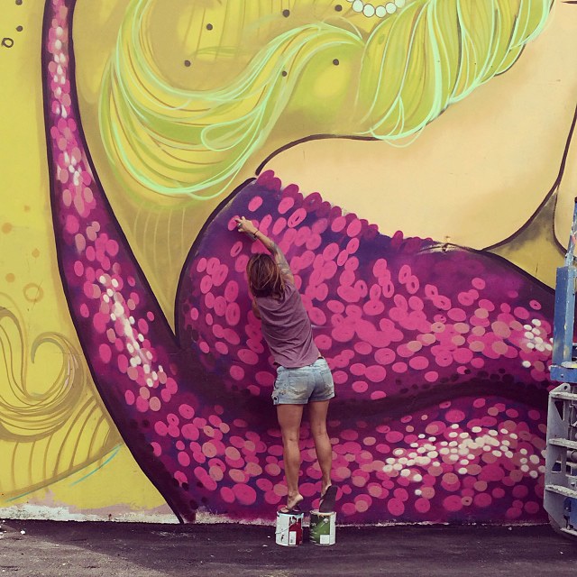 Tatiana Suarez painting a mural in Hollywood