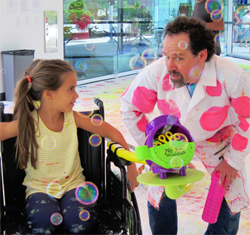 Photo taken by Irene Sperber.<br/>  Dwayne Szot demonstrating his bubble chair machine at All Kids <br/>Included Family Fun Day.