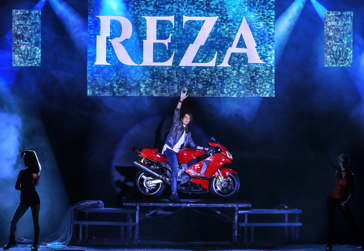 Reza magically appears on a motorcycle in his show 