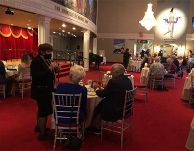 From left: Marilyn Wick (wearing mask on far left) greets her patrons and practices social distancing between tables at the Wick Theatre dinner cabaret show on June 6.