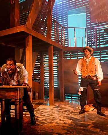 Charles Reuben Kornegay as Gus Colton, a man on the run, is watched by Jaerez Ozolin as lawman Grant Johnson in COWBOY (Photo by Christa Ingraham).