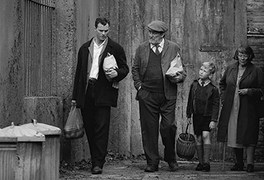 Jamie Dornan, Ciarán Hinds, Jude Hill and Judi Dench in a scene from