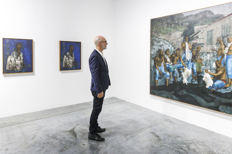 A visitor looks at a work in the NOVA sector at a previous Art Basel Miami Beach. (Photo: Art Basel Miami Beach)