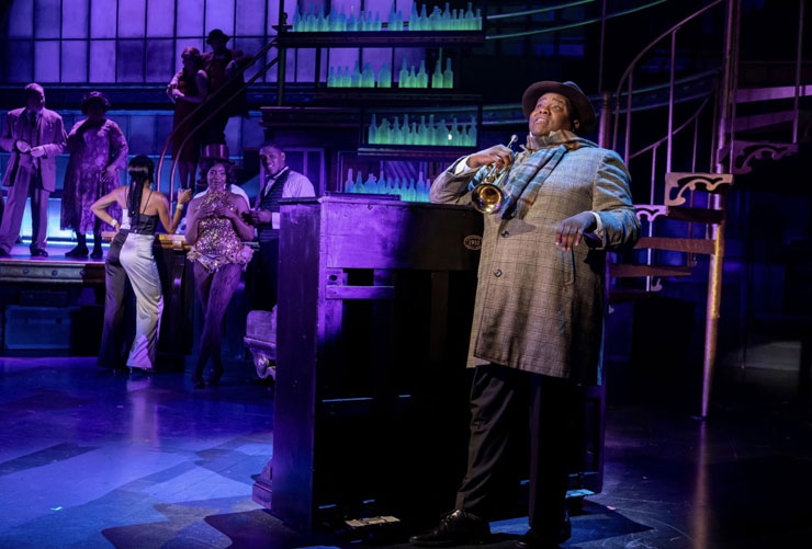Juson Williams as Louis Armstrong, with the company of