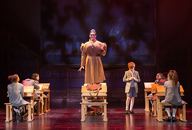 Bryan Austermann, center, is the wicked Miss Trunchbull in Slow Burn Theatre's 