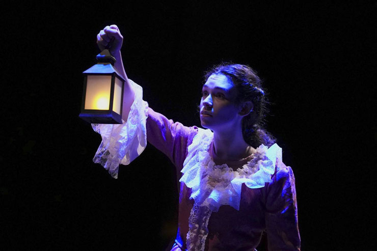 Belle (Michelle Gordon) walks through the woods in Area Stage Company's production of 