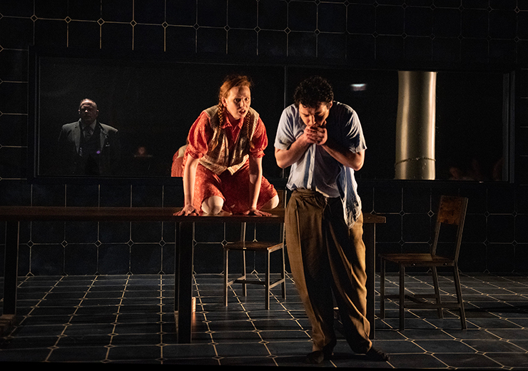 A guard watches as Sophie Scholl (Meredith Casey) and Hans Scholl (Bobby Eddy) spend a moment together. (Photo by Magnus Stark)