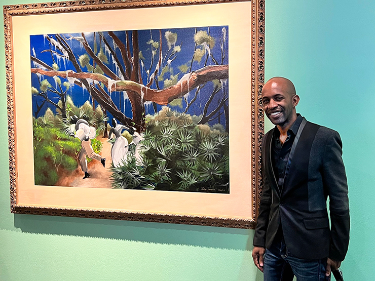 Pedro Jermaine, vice president of Real Rosewood Foundation and Resident Artist, with his work 