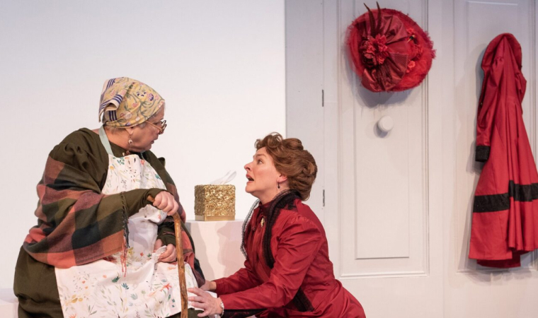Nora Helmer (Rachel Burttram) begs her family's nanny, Anne Marie (Elizabeth Dimon) for help in GableStage's production of 