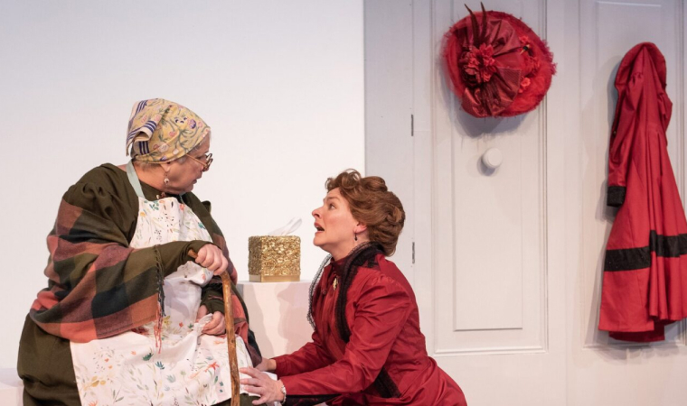 Nora Helmer (Rachel Burttram) begs her family's nanny, Anne Marie (Elizabeth Dimon) for help in GableStage's production of