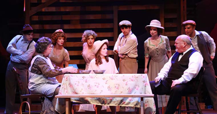 Paulette Oliva, Kimberly Doreen Burns, and Peter McClung fight over their family's future as the ensemble listens in. (Photo by Alberto Romeu)