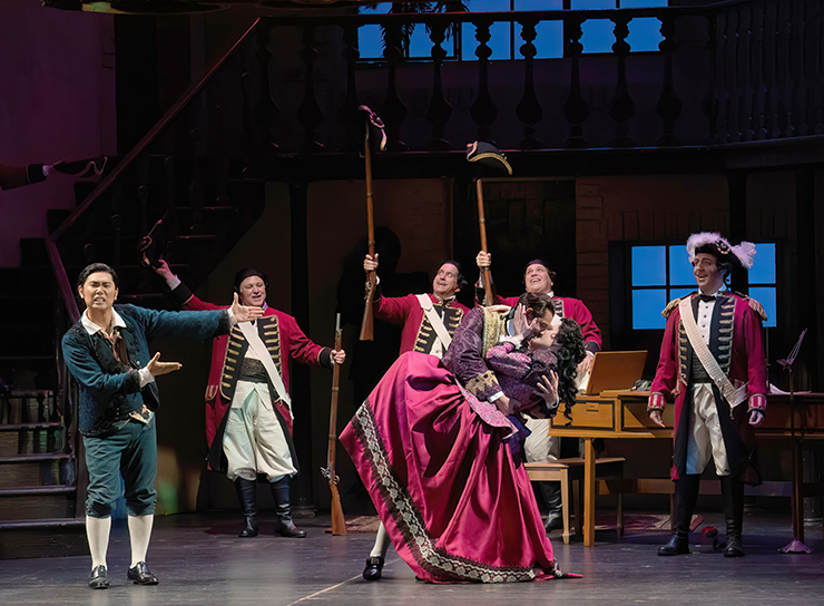 Count Almaviva (Michele Angelini) and his intended, Rosina (Stephanie Doche) rejoice under the eyes of Figaro (Young-Kwang Yoo), the Officer (Matthew Cossack), and the soldiers. (Photo by Daniel Azoulay)