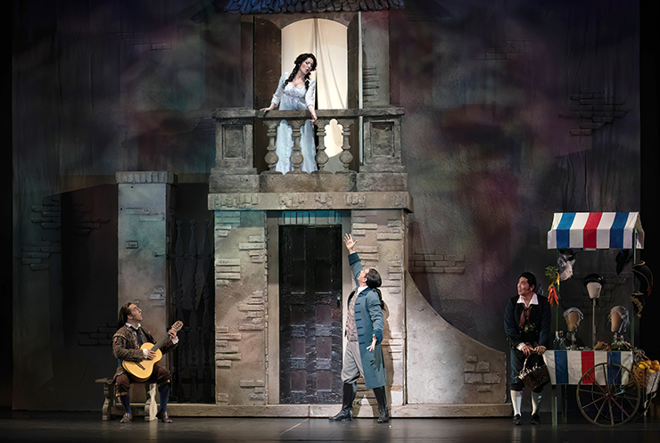 At Figaro's (Young-Kwang Yoo) encouragement and accompanied by Fiorello (Matthew Cossack), Count Almaviva (Michele Angelini), in disguise as a student, serenades the lovely Rosina (Stephanie Doche). (Photo by Daniel Azoulay)