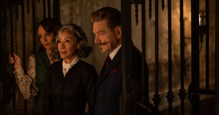 Tina Fey as Ariadne Oliver, Michelle Yeoh as Joyce Reynolds and Kenneth Branagh as Hercule Poirot in a scene from 
