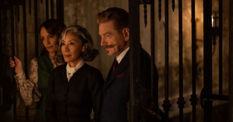 Tina Fey as Ariadne Oliver, Michelle Yeoh as Joyce Reynolds and Kenneth Branagh as Hercule Poirot in a scene from