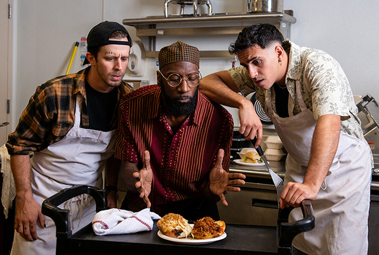 Kristian Bikic, Randy Coleman, Gabriell Salgado study a sandwich in Zoetic Stage's