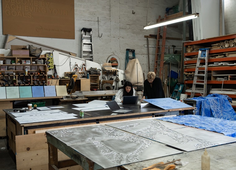 Mette Tommerup and Patricia Aguilar, designer, surrounded by the engraved plates in the Hialeah studio. The mock-ups will become 