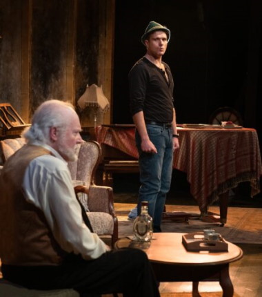 Professor Mashkan (Keith Baker) contemplates something as Stephen Hoffman (Teddy Warren) looks on, sporting a Tyrolean hat. (Photo by Magnus Stark)