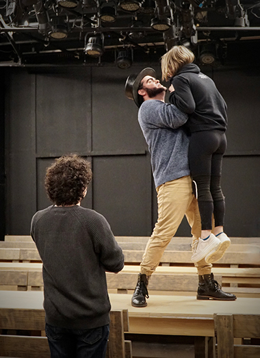 Area Stage Artistic Director Giancarlo Rodaz looks on as Frank Montoto and Hallie Walker rehearse a scene from ASC's upcoming production of 