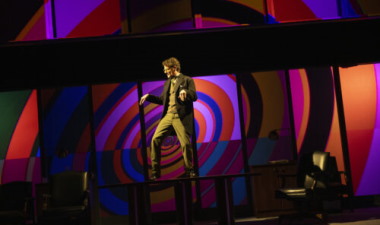 Mark H. Dold dances on a boardroom table as Bobby Lehman. (Photos by Magnus Stark)