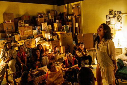 Susie K. Taylor as Avery in her bedroom filled with boxes in Juggerknot Theatre's