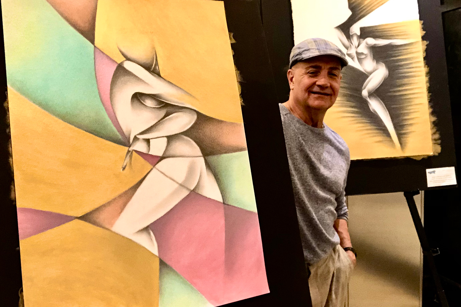 Noel Suarez with one of his works in the Artist Loft where he is artist in residence on Oceania Cruises. (Photo courtesy of the artist)