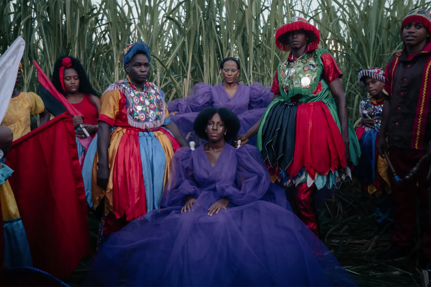 Yelida Diaz as Makenya and Ruth Emeterio as Filomena (center, in purple) in a scene from 