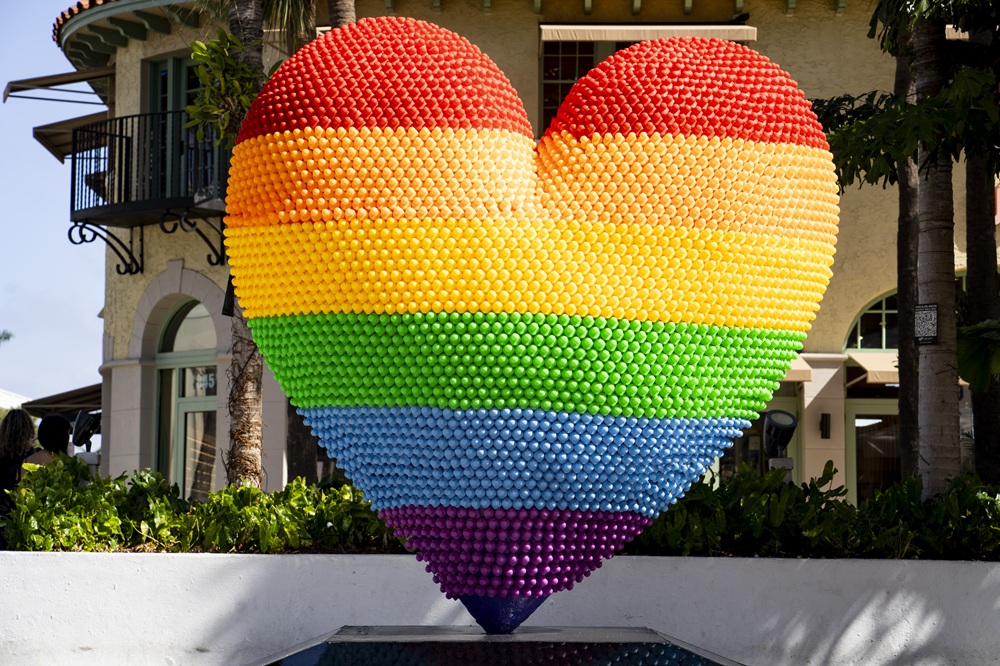 Proud Love at 850 Lincoln Road rises 10-feet-tall in the form of a glowing heart, constructed from nearly 7,000 upward-facing rubber ducks.