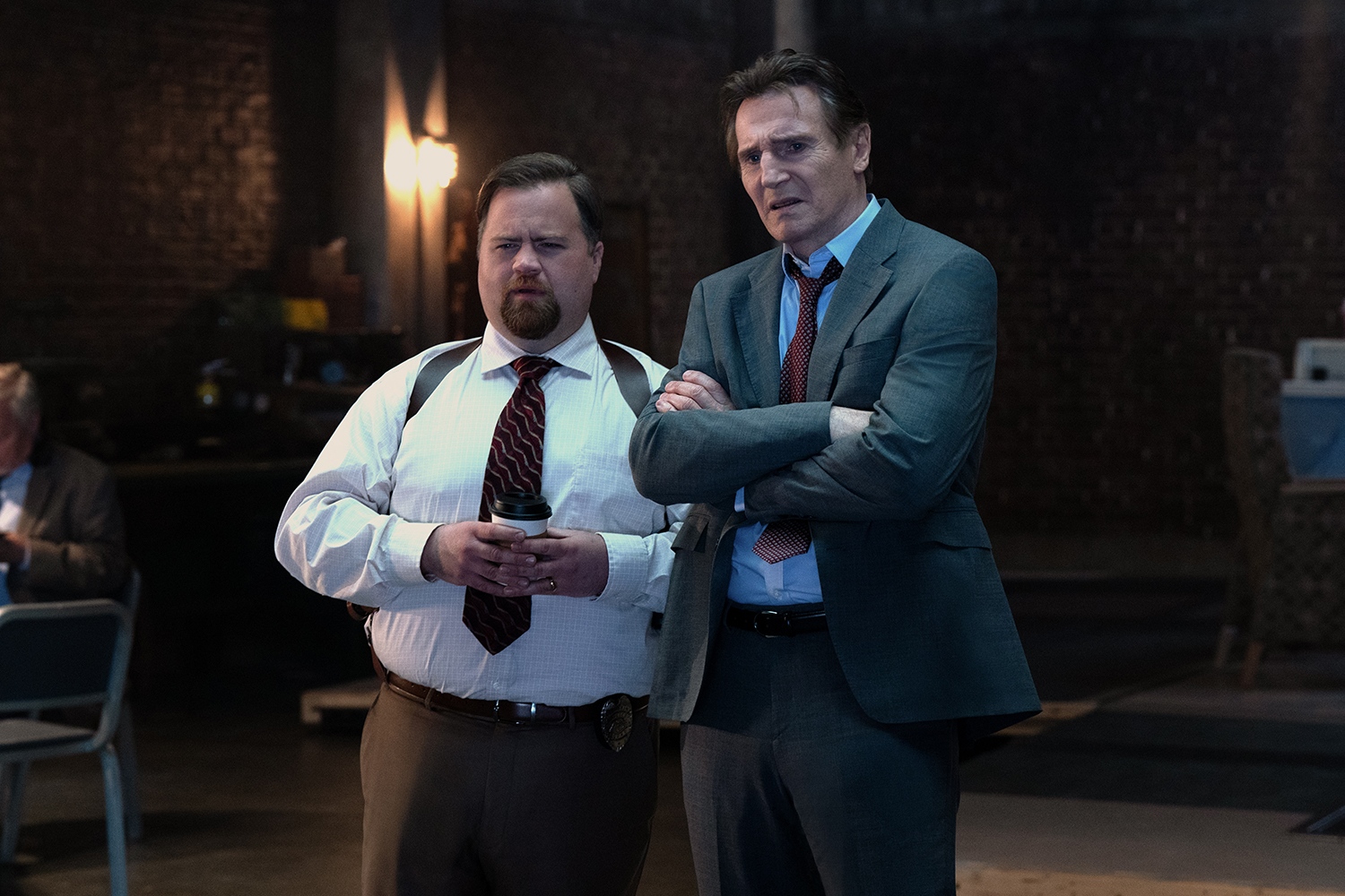 Paul Walter Hauser as Ed Hocken Jr. and Liam Neeson as Frank Drebin Jr. in a scene from