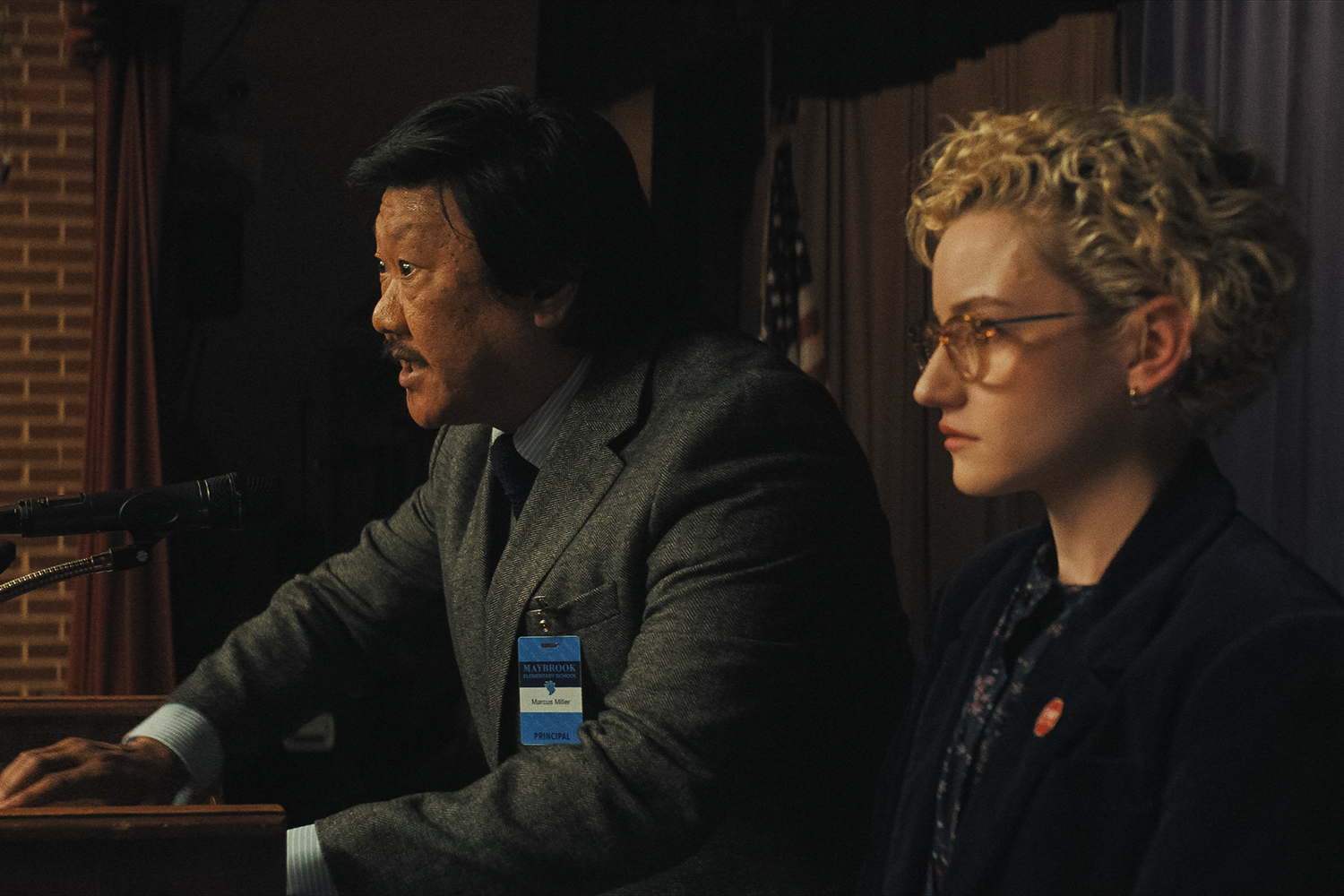 Benedict Wong as Principal Andrew Marcus and Julia Garner as Justine Gandy in a scene from