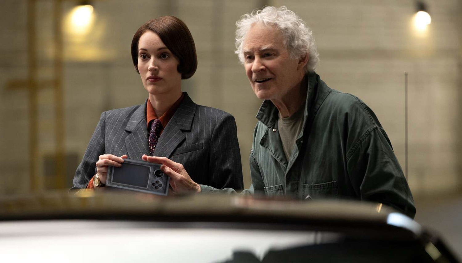 Phoebe Waller-Bridge as Female Cashier and Kevin Kline as The Mechanic in a scene from 