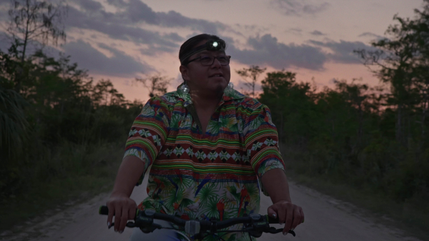 Reverend Houston R. Cypress rides a bicycle at sunrise in the documentary