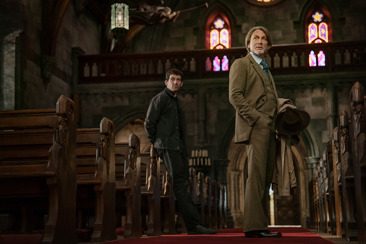 Josh O'Connor as Father Jud Deplenticy and Daniel Craig as Benoit Blanc in a scene from 