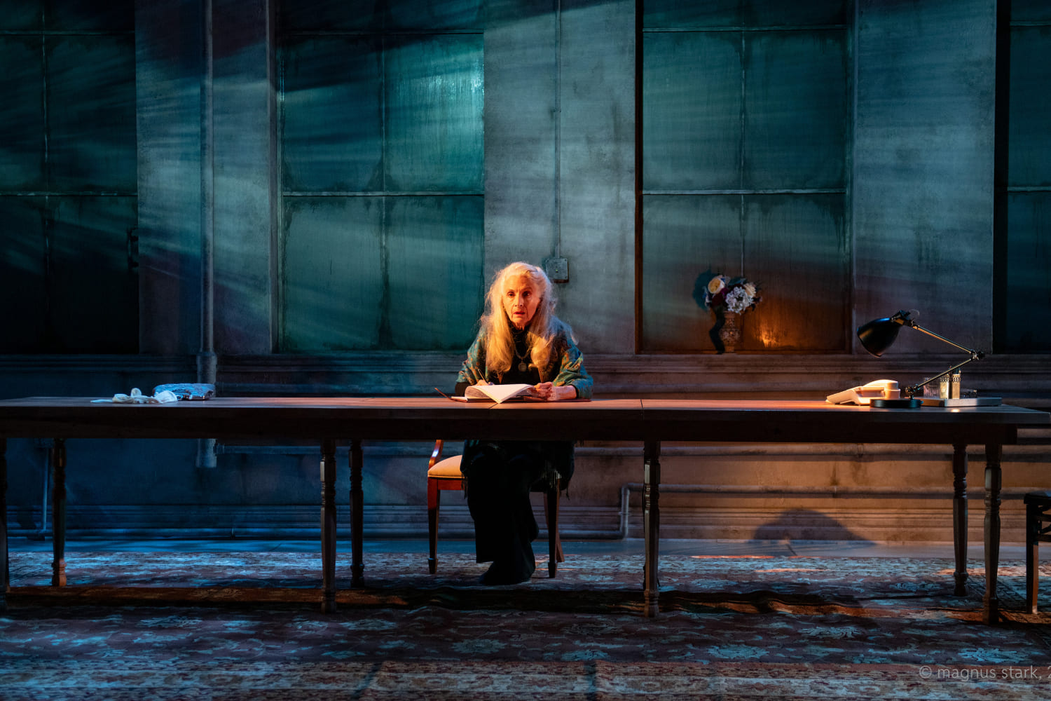 Bemadette Kahn (Sara Morsey) writes while she's alone in GableStage's production of 