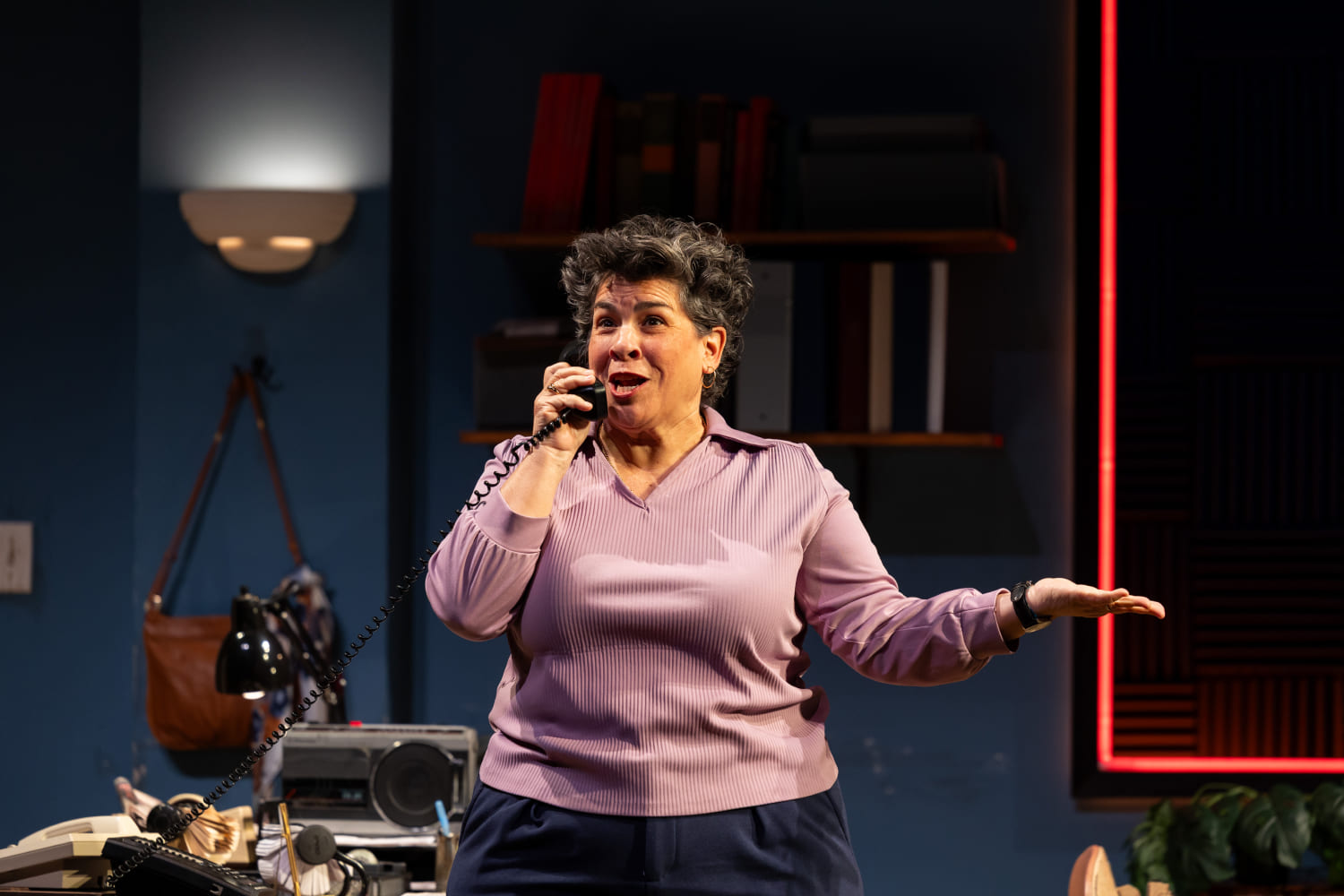 Lucy Alvarez (Carmen Pelaez) talks on the phone. (Photo by Morgan Sophia Photography/courtesy of Miami New Drama)
