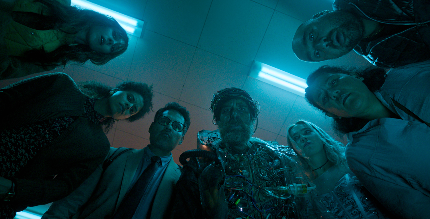 Juno Temple as Susan, Zazie Beetz as Janet, Michael Peña as Mark, Sam Rockwell as The Man from the Future, Haley Lu Richardson as Ingrid, Georgia Goodman as Marie and Asim Chaudhry as Scott in a scene from 