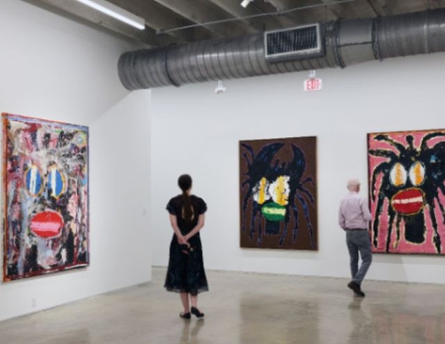 Visitors to Mindy Solomon Gallery look at Zambian-born, Copenhagen-based artist Jack Kabangu's work. The artist's first solo exhibition, 