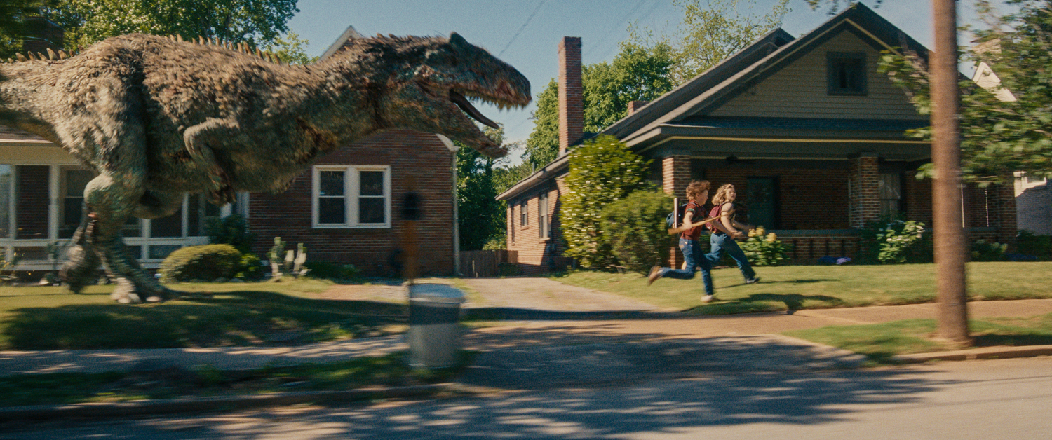 A hungry T. rex, Christian Convery as Brian Platt and Maisy Stella as Audrey Platt in a scene from 