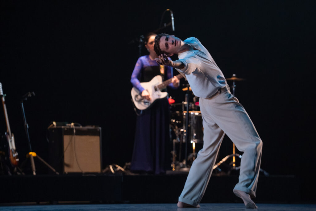 Dancer Cameron Catazaro and musician Emily Estefan, shown in background, in “Push the Buttons of the Civilized” by Patricia Delgado. (Photo by REN Media, courtesy of MCB).