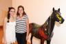 Isabel and Carolina Villeda next to Simon Ma’s fiberglass sculpture titled "Horse Dipped Art"