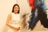 MaDesign Marketing Manager Hilda Chan next to Simon Ma’s acrylic on canvas piece titled "Colors Joy"