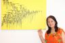 Regine Chan, proudly poses next to her son’s painting titled "Chinese Graffiti"
