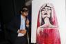 Joseph Zayas Bazan poses next to Kazilla's finished artwork