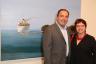 Former Mayor of Miami Beach Neisen Kasdin with Ana Kasdin next to Julio Larraz's "Where the Santa Ana Meets the Sea"