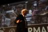 Hollywood celebrity actor Richard Gere waves to audience as he makes his way on stage.