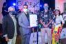 Tito Puente Jr., center left, receives Tito Puente Sr. Day proclamation from Miami Beach Mayor Dan Gelber with Ray Breslin, at left and Ceci (Ana Cecilia) Velasco at right