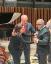 Gloria Estefan adjusts her husband Emilio's Frost Centennial Medallion