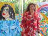 Artist Talia Zoref with her paintings