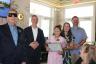 Scholarship Winner Christa Pineda reading her scholarship certificate in Braille, 			surrounded by David New, Miami Beach Mayor Steven Meiner, her mother, and 			Miami Beach Commissioner Alex Fernandez.